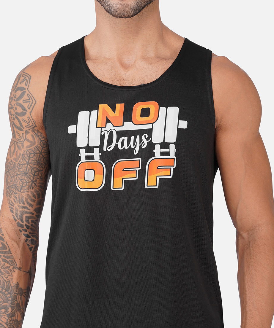 A man wearing a black sleeveless tank top with a graphic that reads 'NO Days OFF' in orange and white over a barbell illustration, shown against a light gray background.