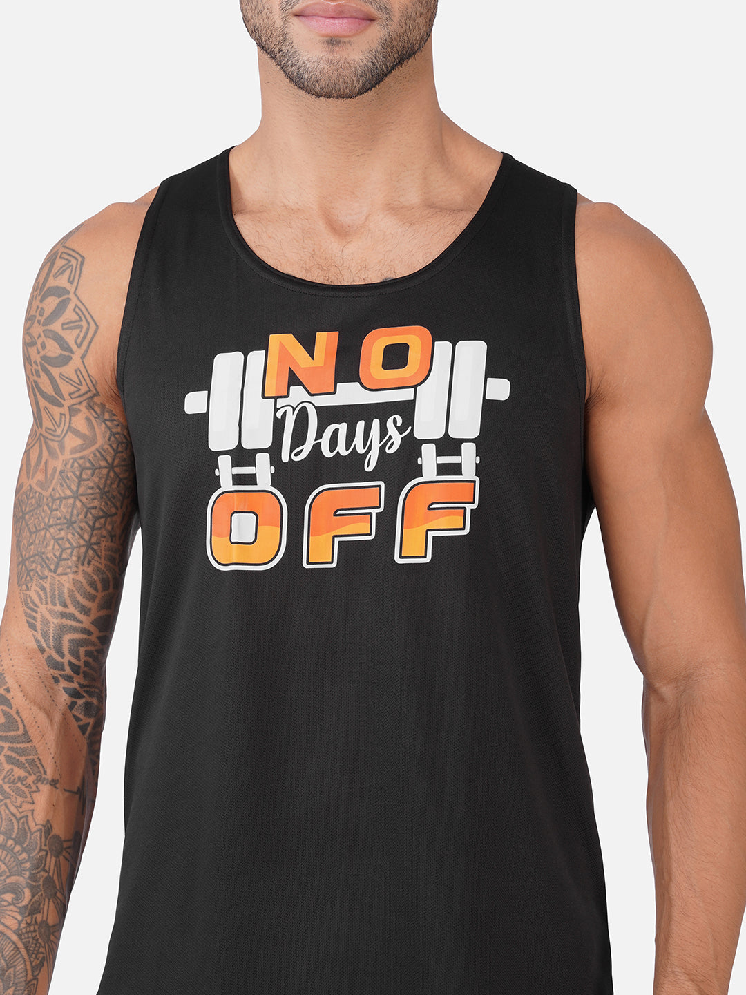 A man wearing a black sleeveless tank top with a graphic that reads 'NO Days OFF' in orange and white over a barbell illustration, shown against a light gray background.