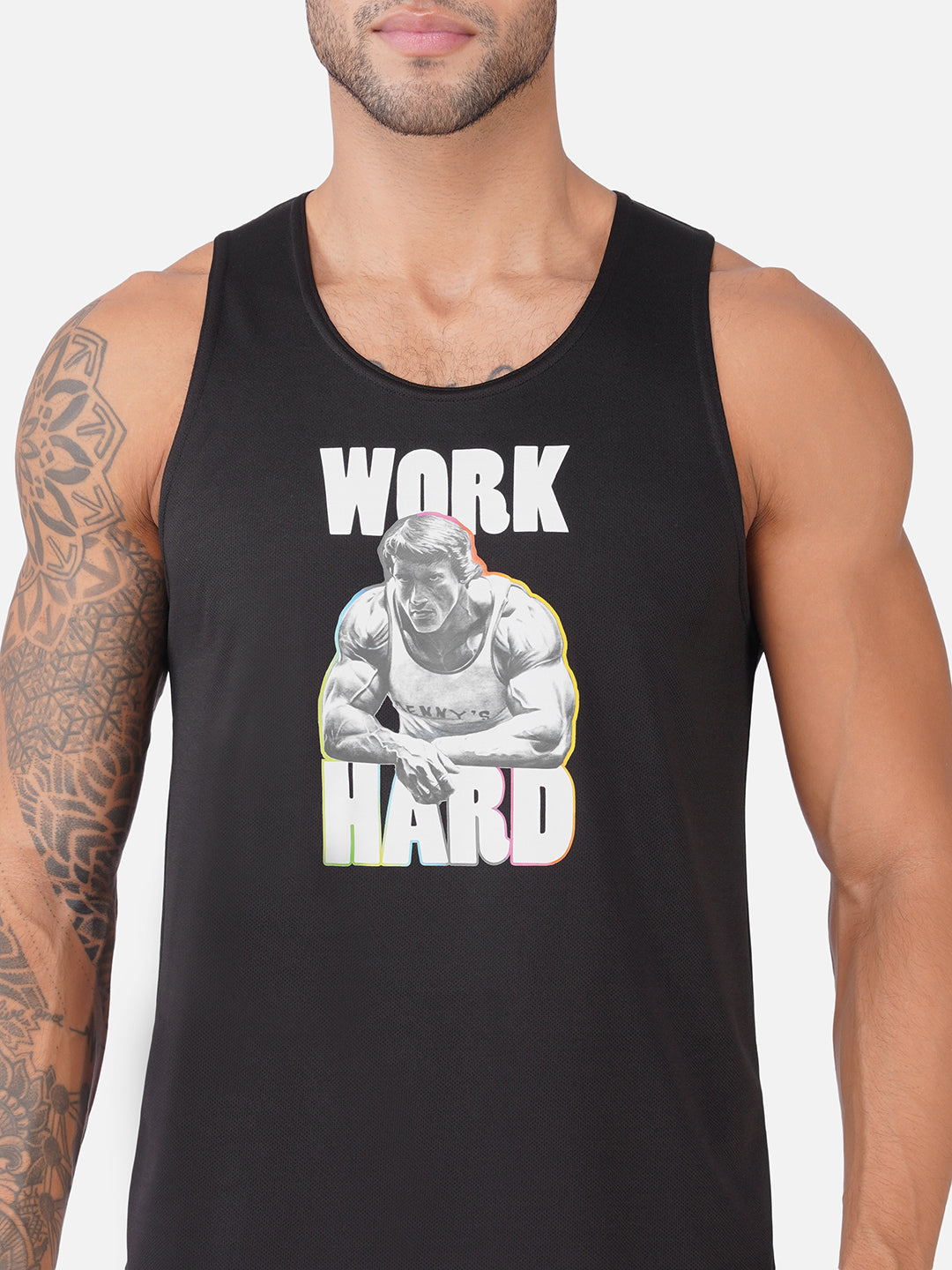 A man wearing a black tank top with a graphic print that reads 'WORK HARD' in white letters around an illustration of a muscular man lifting weights.
